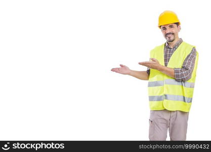 Cheerful male contractor wearing helmet and reflective vest isolated on white background pointing aside while looking at camera. Builder in hardhat and reflective vest on white background
