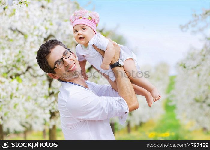 Cheerful man holding his beloved child