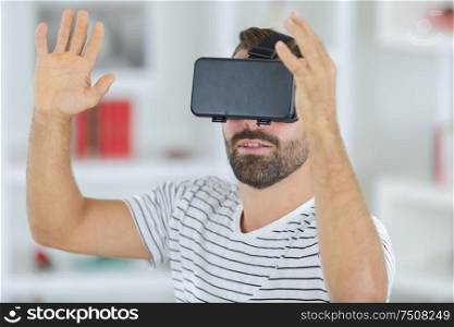 cheerful man wearing virtual reality headset