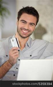 Cheerful man with credit card