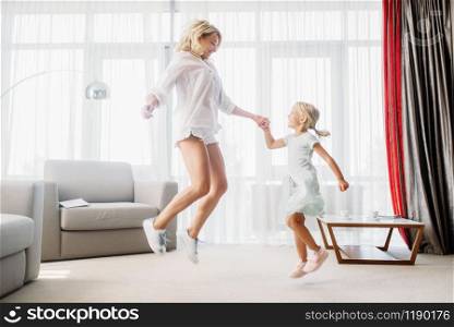 Cheerful mother and daughter, funny game at home. Parent feeling, togetherness, happy family