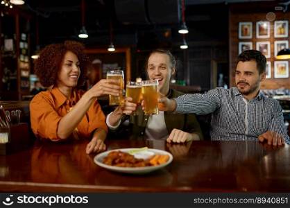 Cheerful old friends having fun and drinking draft beer in sports bar. Diverse happy young people clinking glasses and celebrating victory while rest in pub. Cheerful old friends having fun and drinking draft beer in sports bar