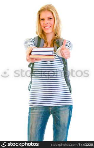 Cheerful pretty girl with backpack and books showing thumbs up isolated on white &#xA;