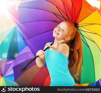 Cheerful redhead girl with an umbrella