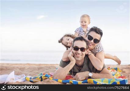 Cheerful, relaxed family posing on a beautiful beach