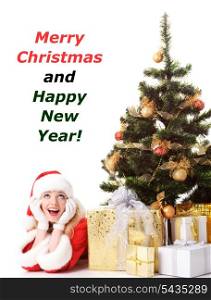 cheerful santa girl lie near the gift and New-year&rsquo;s tree. Copy text. Christmas greetings card