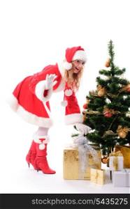 cheerful santa girl stand near the gift and New-year&rsquo;s tree. Copy text. Christmas greetings card