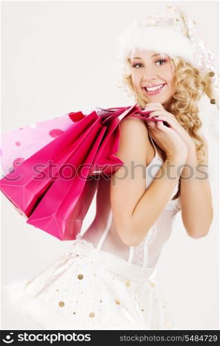 cheerful santa helper with pink shopping bags