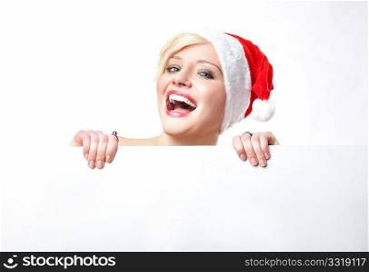 Cheerful santa woman holding empty white board