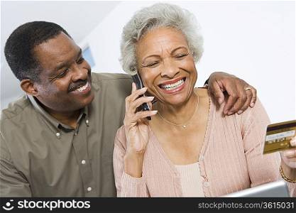 Cheerful Senior Couple Managing Home Finances