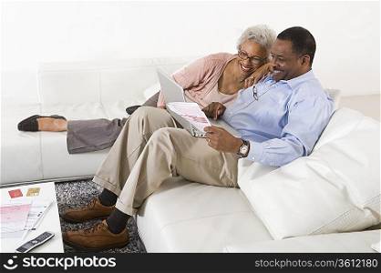 Cheerful Senior Couple Using Laptop