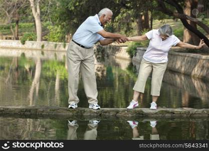 Cheerful senior man and woman having fun at park