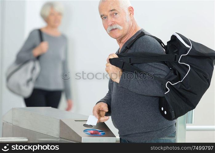 cheerful senior man entering gym