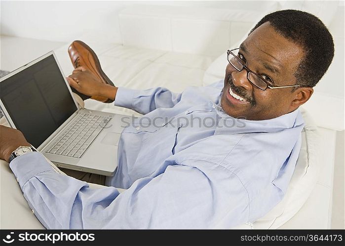 Cheerful Senior Man Using Laptop