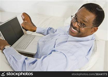 Cheerful Senior Man Using Laptop
