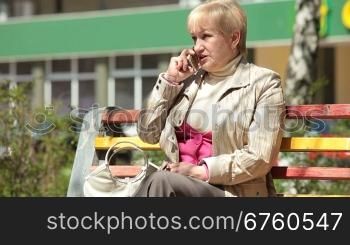 Cheerful Senior Woman Talking On The Phone Outdoors