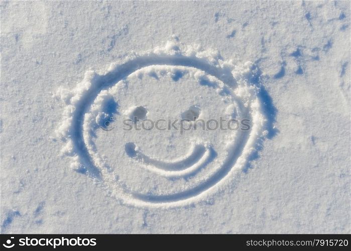 cheerful smiley face drawn on snow