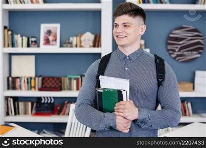 cheerful student with textbook notebook