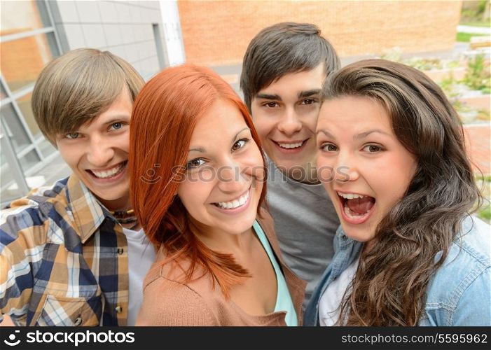 Cheerful teenager friends taking selfie having fun outside campus