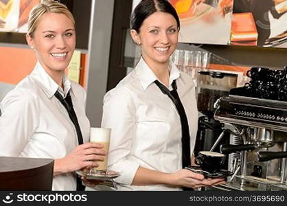 Cheerful waitresses serving hot coffee in bar in uniform