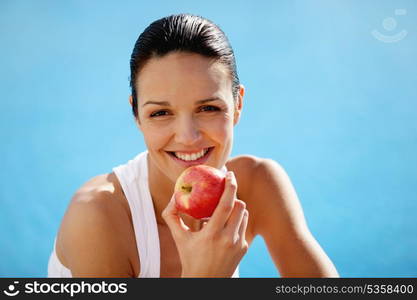 Cheerful woman eating an apple