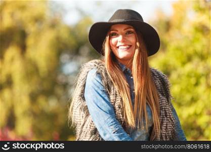 Cheerful woman having fun outdoors. Autumnal happiness idea. Happy cheerful young woman in black hat outdoor. Joyful attractive girl having fun in park.