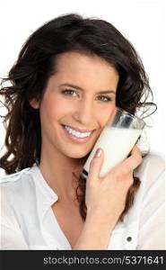 Cheerful woman holding milk