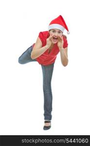 Cheerful woman in Christmas hat shouting through megaphone shaped hands