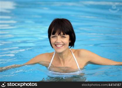 Cheerful woman in swimming pool