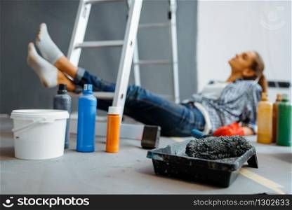 Cheerful woman makes home repair, happy female person doing appartment renovation, room decoration renovating. Cheerful woman makes home repair
