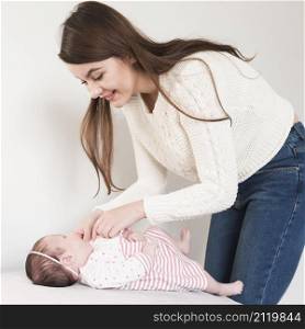 cheerful woman taking care baby