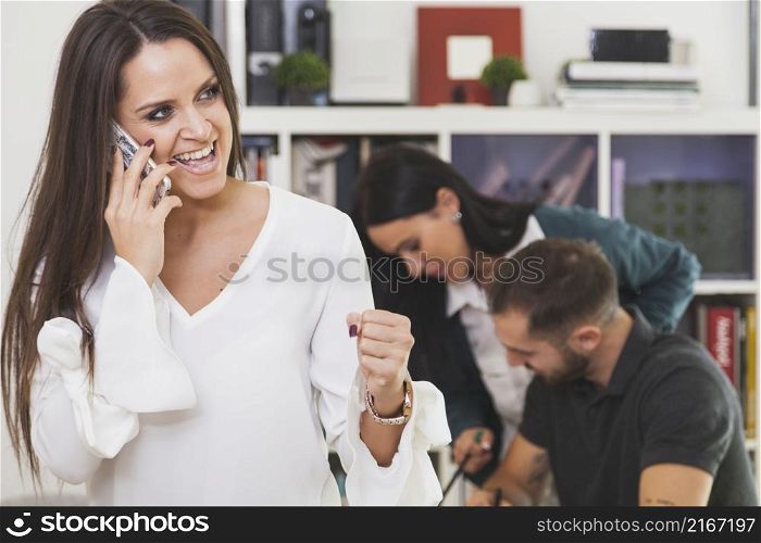 cheerful woman talking phone celebrating