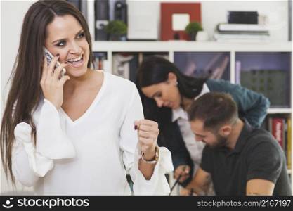 cheerful woman talking phone celebrating