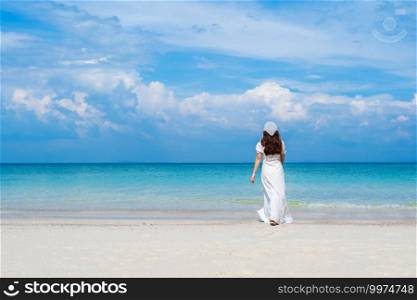 cheerful woman walking on the sea beach at Koh MunNork Island, Rayong, Thailand
