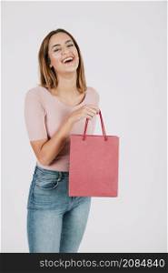 cheerful woman with paper bag