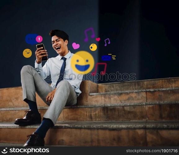 Cheerful Young Asian Businessman Using Mobile Phone in the City. Enjoying Social Media application. surrounded by many icons