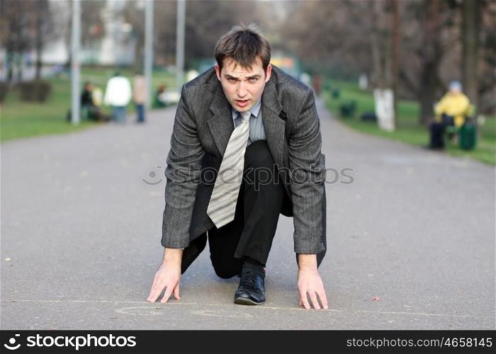 Cheerful young businessman walking on the street