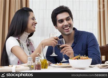 Cheerful young couple enjoying the meal at restaurant