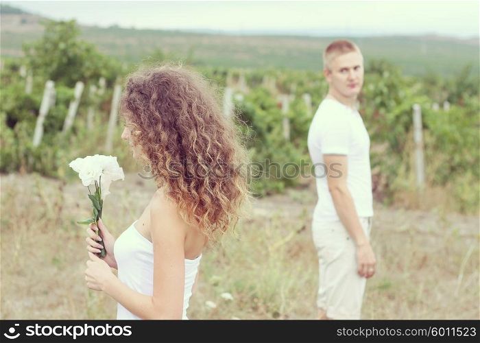 Cheerful young couple in the fields
