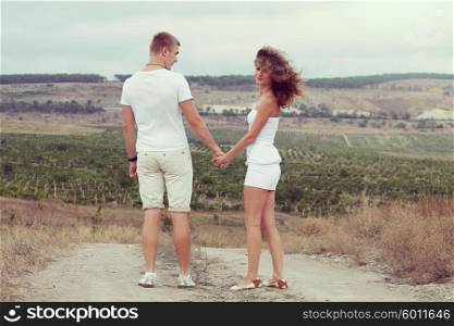Cheerful young couple in the fields