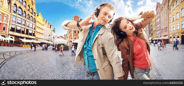 Cheerful young couple listening to music