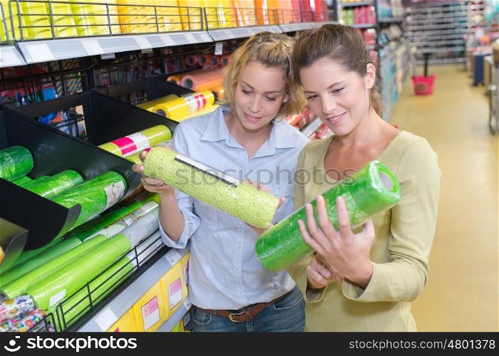 cheerful young couple of friends shopping in hardware store