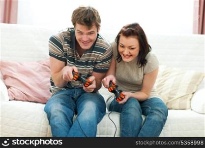 Cheerful young couple playing console