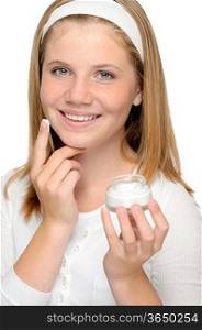 Cheerful young girl applying moisturizer face cream fingers