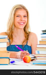 Cheerful young girl sitting at table with lots of books&#xA;