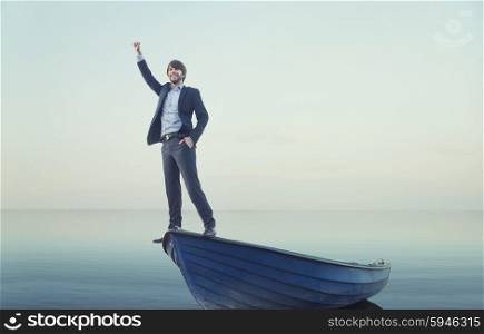 Cheerful young guy on the tiny boat