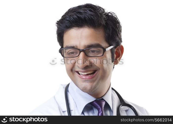 Cheerful young male doctor smiling over white backgroundCheerful young male doctor smiling over white background