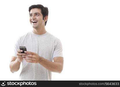 Cheerful young man holding cell phone on white background