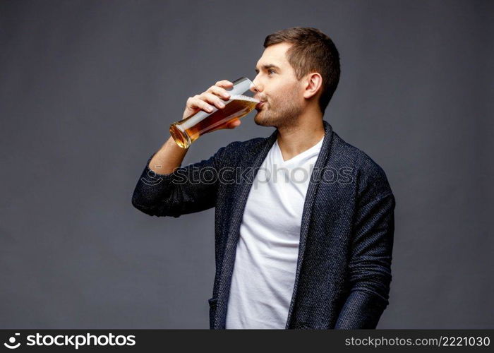 Cheerful young man in smart casual wear against grey background. Cheerful young man in smart casual wear