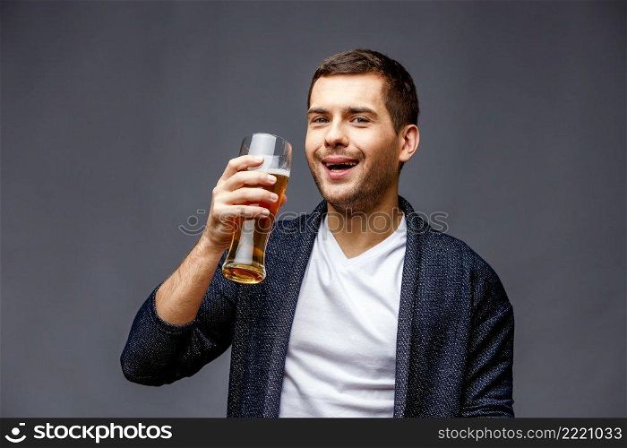 Cheerful young man in smart casual wear against grey background. Cheerful young man in smart casual wear